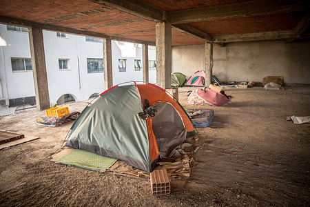 Tents and mattresses are seen in an unfinished building in Tunis which is home to refugees and migrants who are hoping to cross the Mediterranean Sea to Europe. Tunisia has become the top departure country for people who are trying to reach Europe by crossing the Mediterranean Sea on the so-called Central Mediterranean migration route, which the UN has called the deadliest in the world.