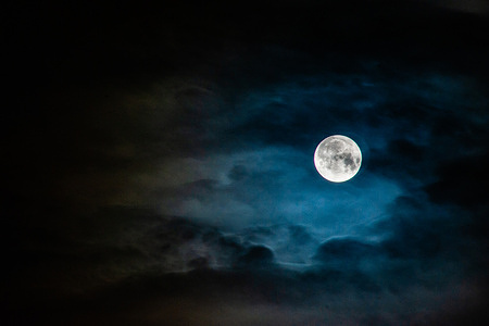 The Blue moon can be seen surrounded by clouds reflecting blue light. Shortly after 8:30 p.m. Eastern time, through the morning of Sept. 1, a rare “super blue moon” rose in the skies, creating a spectacle that thrills photographers, the full moons is a supermoon NASA says.