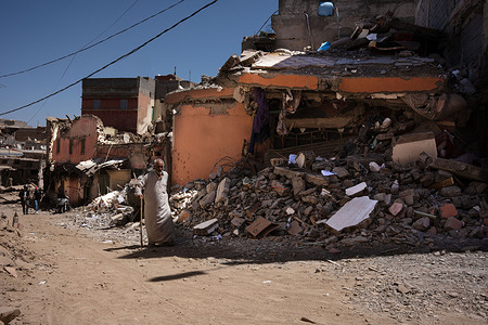 An elderly man with a walking stick walks past a collapsed house in the city of Azizmiz. The earthquake in Morocco on Friday 8 September was the worst in the country's history, leaving more than 2,000 people dead.