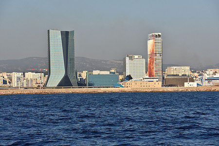 View of the CMA-CGM tower by architect Jean Nouvel (L) and the La Marseillaise tower by architect Zaha Hadid (R).