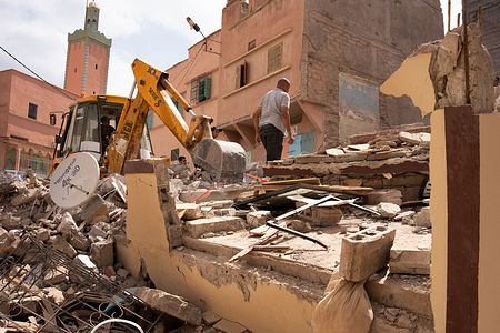 Men remove debris from a collapsed house with a backhoe in the small town of Amizmiz. The region of Amizmiz was one of the worst affected by the earthquake in Morocco on Friday 8 September, which killed more than 3,000 people. Tens of thousands of people have been left homeless.