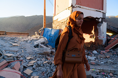 A Moroccan woman is seen walking on the rubble and remains of destroyed buildings following the earthquake. Aid and rescue operations are still ongoing and slowly reaching most remote villages affected by the earthquake in Morocco. Hundreds of bodies are still thought to be buried under the rubble, while survivors are forced to live in makeshift camps. Almost 3,000 people are reported to have died in the earthquake.