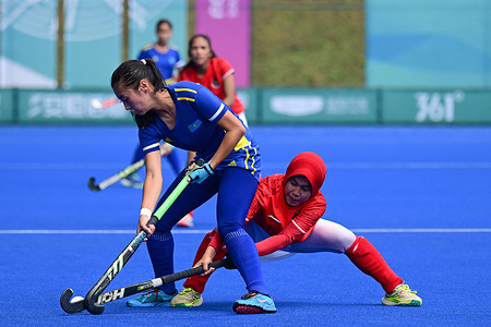Dilnaz Khairusheva (L) of the Kazakhstan women hockey team and Nur Anisa (R) of the Indonesia women hockey team seen in action during the 19th Asian Games 2023 women's hockey Pool B Preliminary round match between Kazakhstan and Indonesia at Gongshu Canal Sports Park Stadium. Final score; Kazakhstan 2:1 Indonesia.