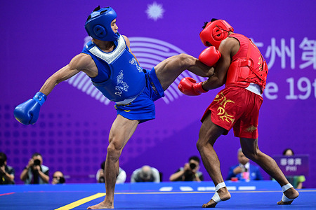 Arnel Mandal (R) of the Philippines and Jiang Haidong (L) of China compete during the Asian Games 2023, Wushu Sanda Men's 56Kg Final match at Xiaoshan Guali Sports Centre. Jiang won the match by point difference.