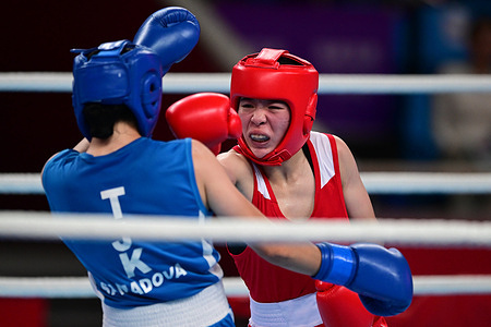 Huyen Tran Nguyen (R) of Vietnam and Mijgona Samadova (L) of Tajikistan are seen during the 19th Asian Games women's boxing 54-57Kg Preliminaries R16 match held at the Hangzhou Gymnasium. 
Samadova won with a unanimous decision from the judges.