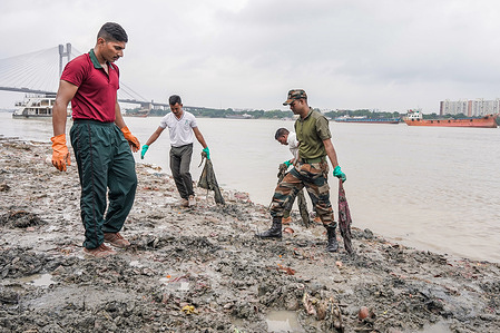 Army personnel of Gorkha Regiment clean the garbage on the bank of the river Ganges in Kolkata as they take part in "Swachh Bharat Mission" (cleanliness drive led by Indian prime minister Narendra Modi). Citizens of India take part in the cleanliness drive ahead of Gandhi Jayanti to celebrate the birth anniversary of Mahatma Gandhi (anti colonial nationalist). People from various fields, join this mission with a promise to keep the environment clean.
