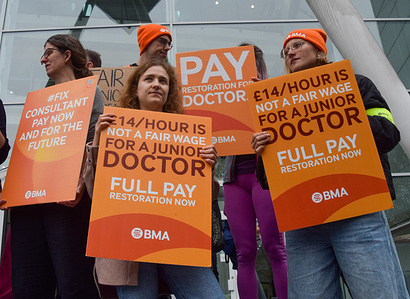 Doctors stand with placards in support of fair pay at the British Medical Association (BMA) picket outside University College Hospital, as NHS (National Health Service) consultants and junior doctors continue their joint strike over pay.