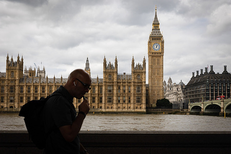 A silhouette of a man is seen near the Palace of Westminster in London.