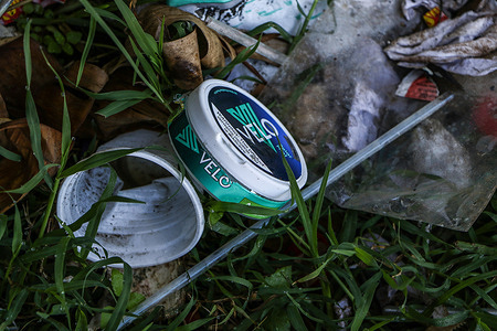 In this photo illustration, a discarded plastic container from British American Tobacco's (BAT) Velo brand of nicotine is seen among the litter. Kenyan parliament is debating to ban the Velo brand of nicotine pouches made in Hungary by British American Tobacco, with concerns arising from the substance addictiveness and potential adverse health effects on users.