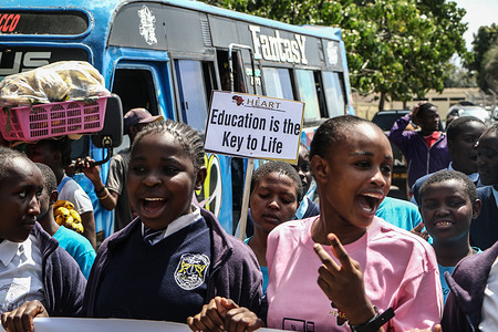 Pupils march while holding placards during a rally to observe International Day of the Girl Child in Nakuru Town.