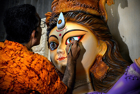 An Artist makes final touches of the Durga idol in his Artist Studio just ahead of the Biggest Hindu Festival - Durga puja. Dashain festival is the greatest and longest festival of Nepalese people as it marks the victory of the goddess Durga over the demon Mahishasura. Dashain is dedicated to the goddess Durga, who is seen as a symbol of power and divine energy. Devotees offer prayers and sacrifices to the goddess during this time.