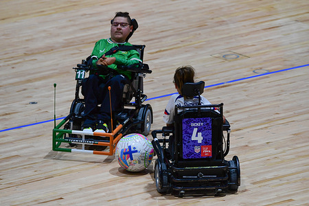 Naglis Montvilas (L) of the Republic of Ireland powerchair football team and Natalie Russ-Dickey (R) of the United States of America powerchair football team seen in action during the FIPFA Powerchair Football World Cup 2023 match between USA and Republic of Ireland at Quaycentre. Final score; USA 2:0 Republic of Ireland.