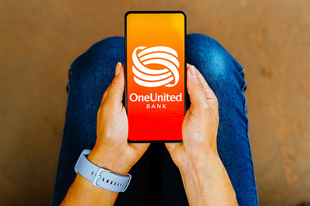 In this photo illustration, the OneUnited Bank logo is displayed on a smartphone screen.