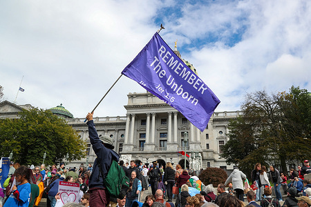 A protester holds a flag during the third annual Pennsylvania March for Life. Thousands of people came together at the Pennsylvania Capitol to express their anti-abortion views during the Pennsylvania March for Life.