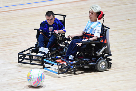 Jordan Dickey (L) of the United States of America powerchair football team and Valentino Zegarelli (R) of the Argentina powerchair football team seen in action during the FIPFA Powerchair Football World Cup 2023 match between USA and Argentina at Quaycentre. Final score; USA 2:1 Argentina.