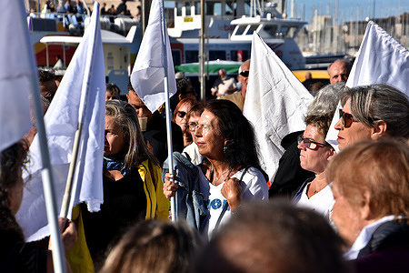 Protesters holding white flags are seen gathering at the Old Port of Marseille during the demonstration. At the call of organizations such as the Abbé Pierre Foundation, Emmaüs and the Human Rights League, people gathered at the Old Port of Marseille for peace.