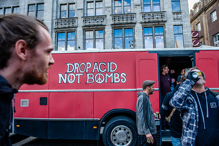 One of the trucks is seen with a message written against war during the demonstration. The organization Amsterdam Dances For A Cause (ADEV) held its 11th annual protest in support of squatting, creating open spaces, and making housing more affordable in the city. Participants danced alongside big trucks blaring music to advocate for having more free spaces in the city. The event began with a performance highlighting opposition to consumerism, where people danced naked.