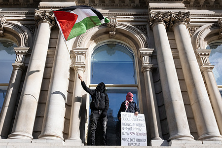 Two protestors are seen waving a Palestinian flag and holding a placard demanding for an end to Israel’s bombardment of Gaza during the demonstration. Following the first march on 7 October, about 100,000 pro-Palestinian protestors, claimed by The Metropolitan police, joined a march in central London to show solidarity with Palestinian and call for an end to Israel’s bombardment of Gaza. The protestors assembled at Marble Arch and marched down to Parliament Square.
