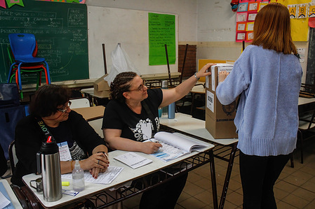 A voter casts her vote at a polling station during the 2023 Argentina presidential elections.