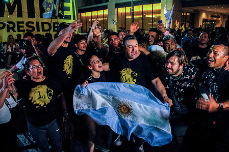 Supporters chant slogans as they demonstrate their support for Javier Milei, in the context of presidential elections. Adherents gathered outside Javier Milei's headquarters, in the context of the 2023 Argentine presidential elections. Resulting in a runoff between Sergio Massa and Javier Milei.