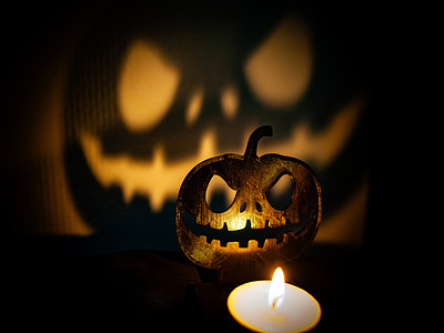 A pumpkin candle throws a scary shadow. The Halloween celebration is becoming increasingly popular in the Netherlands. Halloween is a holiday celebrated each year on October 31 and is also known as All Saints Day. It has evolved into a day of activities that involves decorating homes with spooky paraphernalia, trick-or-treating and carving pumpkin lanterns.