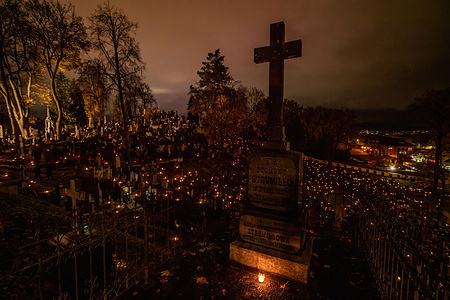 Candles are lit on the tombs to mark the All Saints' Day at the Rasos cemetery in Vilnius. All Saints' Day, celebrated on 1 November, is one of the most sacred days in Western Christianity. In Lithuania, All Saints' Day and the Day of Remembrance of the Dead (November 2) are both public holidays. On these days, people visit cemeteries to honor the memory of the dead. They light candles, bring offerings, and spend time at the graves, reflecting on the memories of their loved ones. This tradition is a significant part of the Lithuanian culture, and it serves as a way for families to maintain a connection with their ancestors.