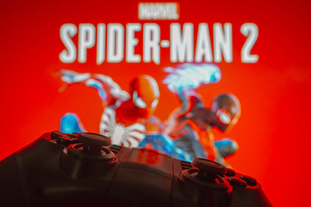 In this photo illustration, the Marvel's Spider-Man 2 logo game is displayed on a computer screen, next to a gamepad.