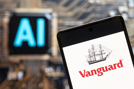 In this photo illustration, the mutual funds and ETFs, brokerage investing services company Vanguard logo seen displayed on a smartphone with Artificial intelligence (AI) chip and symbol in the background.