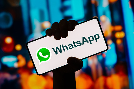 In this photo illustration, the WhatsApp app logo is displayed on a smartphone screen.
