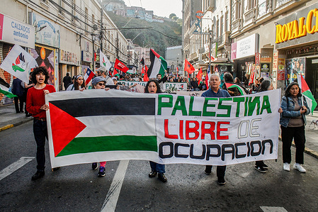 Protesters march with a banner in support of Palestine during the demonstration.