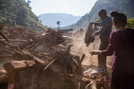 Survivor salvages belongings from a damaged house after the earthquake in village in west rukum, Nepal. As many as 157 people were killed after a 6.4 magnitude earthquake jolted west Nepal late on Friday night According to the National Earthquake Monitoring and Research Center, the earthquake with an epicenter in Jajarkot district, a remote pocket of Nepal, was recorded.
