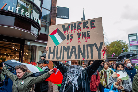 A woman is seen holding a placard expressing her opinion during the demonstration. Hundreds of people took to the streets of the city center of Nijmegen in support of Palestine and to protest Israel's retaliatory attacks on Gaza. The protesters were calling for a ceasefire in Gaza where Israeli attacks have resulted in over 9000 deaths, including thousands of children.