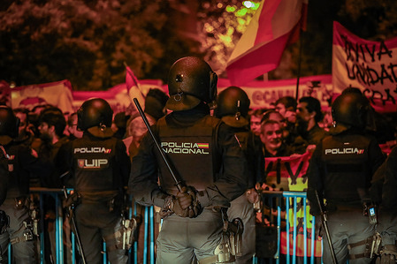 Riot police stand alert during the rally against the amnesty of Catalan politicians and against the acting president of the government of Spain, Pedro Sanchez.