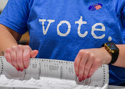 A woman wearing a Vote t-shirt prepares mail-in ballots to be counted at a polling station in Pennsylvania. Municipal Elections in Pennsylvania had a low turnout. In the most recent statistic, about 15% to 27% of eligible voters cast ballots in local elections.