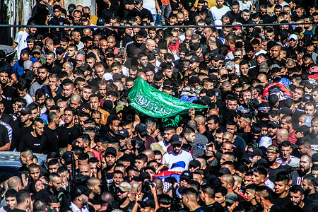 Mourners carry the bodies of four Palestinian militants in Tulakrem refugee camp during their funeral. These Palestinian militants were killed during an encounter with the Israeli forces.