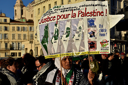 A protester holds a placard during the demonstration against the war in Palestine. Almost 3000 people march in the streets of Marseille in support of the Palestinian people while saying stop the bombings in Gaza.