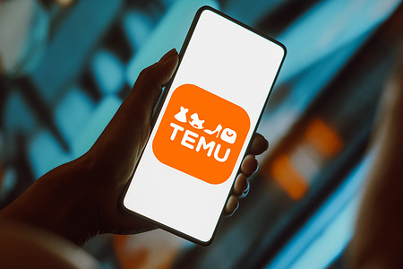 In this photo illustration, the Temu logo is displayed on a smartphone screen.