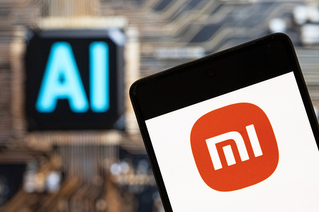 In this photo illustration, the Chinese electronics manufacturer company Xiaomi logo seen displayed on a smartphone with an Artificial intelligence (AI) chip and symbol in the background.