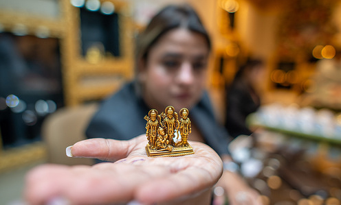 A saleswoman showing antique Gold Ram Darbar Idol on the occasion of Dhanteras at P.P. Jewellers by Pawan Gupta showroom in South Extension Market. Dhanteras is the initial day of the Diwali festival, stemming from "Dhan" for wealth and "Teras" for 13. It occurs on the thirteenth lunar day of Krishna Paksha in the Hindu calendar. Traditionally, Hindus buy gold and silver pieces of jewelry to invite Goddess Lakshmi and Lord Kubera, symbolizing wealth and prosperity, into their homes.