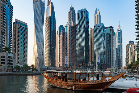 The boat is seen moored with the view of a luxury lifestyle skyscraper apartment complex at the back of Dubai Marina.