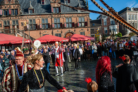 People are seen dancing in circles surrounded by the audience. Every year on the 11th of November at 11:11 pm people gather in the center to count down and celebrate together the beginning of the Carnival season. From this day a council of eleven meets up to discuss the upcoming carnival events. It's a tradition in southern parts of the Netherlands and often the Carnival Prince gets introduced as well.
