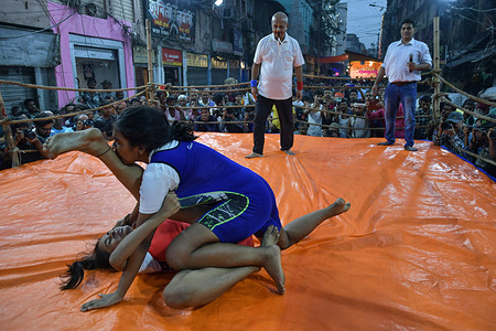 Female Wrestlers participate in an open-air street wrestling competition named “DANGAL”, organized on the occasion of Diwali in the Barabazar area of Kolkata. Every year male and female wrestlers from different age groups participate in the street wrestling competition.