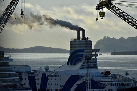 View of the Fantastic spewing out a cloud of black smoke in Marseille. The cruise-ferry Fantastic, docked in the French Mediterranean port of Marseille for maintenance and repairs.
