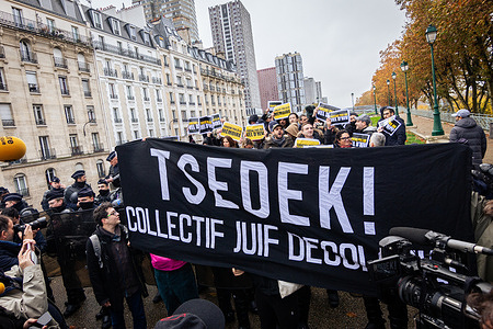 A group of Jews is standing with a banner of TSEDEK during a demonstration against the laying of wreaths in the square of the Jewish martyrs. Leftist political party La France Insoumise organized a laying of wreaths in the square of the Jewish martyrs at the Vélodrome d'hiver in memory of the Jews who were rounded up by French authorities in July 1942. During the ceremony, a group of Jews protested and disrupted the event, criticising La France Insoumise for its policy regarding the Israel-Hamas conflict and accusing them of political opportunism.
