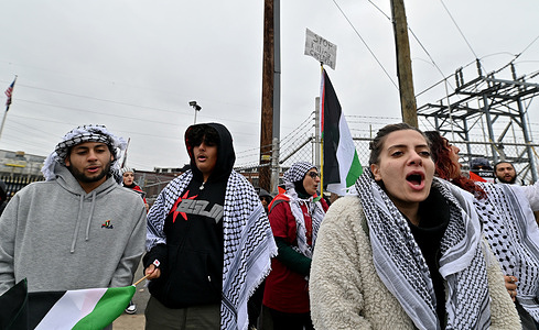 Protesters hold Palestinian flags and chant pro-Palestinian slogans during a demonstration. Protesters against the occupation in Palestine protested outside of the Scranton Ammunitions plant General Dynamics where military ammunition shells are made and are being used in Israel.