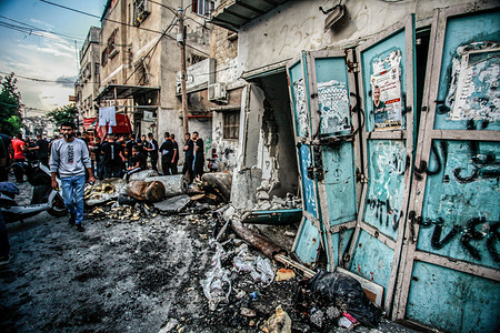 Palestinians inspect a damaged building following an Israeli military raid in the City of Tulkarm in the West Bank. At least seven Palestinians were killed on November 14 during clashes with Israeli soldiers in Tulkarm, northern West Bank. Over 11,000 Palestinians were killed in Israeli strikes on Gaza since October 7.