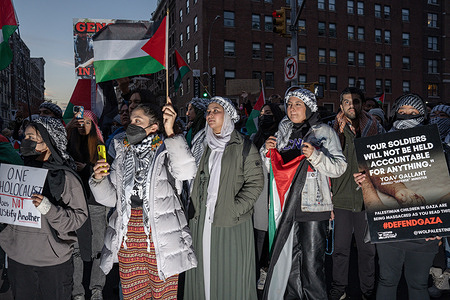 Protesters hold placards and Palestinian flags during the demonstration. Columbia University students hold a demonstration against the administration's suspension of two pro-Palestinian student groups, SJP and JVP.