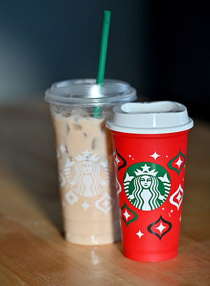 In this photo illustration, a Starbucks red cup and a plastic cup are seen on display. November 16 is the Starbucks Red Cup freebie day. Any customer purchasing a drink can get a free plastic holiday themed cup. Many Starbucks employees chose to walk out in protest of the company.