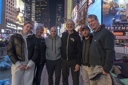 New York Yankees general manager Brian Cashman (3L) poses with participants at a Covenant House's "Sleep Out" to raise awareness for youth homelessness at Times Square in New York City.