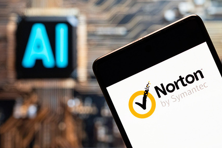 In this photo illustration, the cybersecurity and anti-virus malware software developed by Symantec Corporation, Norton Anti-virus, logo seen displayed on a smartphone with an Artificial intelligence (AI) chip and symbol in the background.